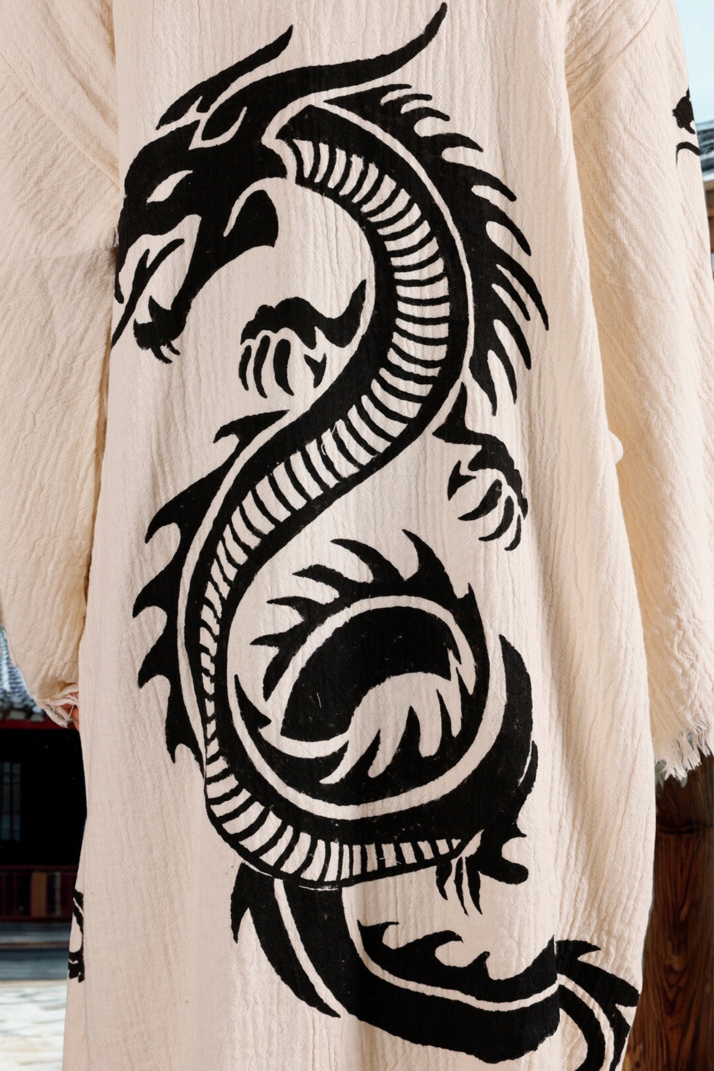 Meraki Beach HAKU Kimono in organic cotton cream, hand block printed with black Japanese dragon design – sustainable, ethical resort wear for women.