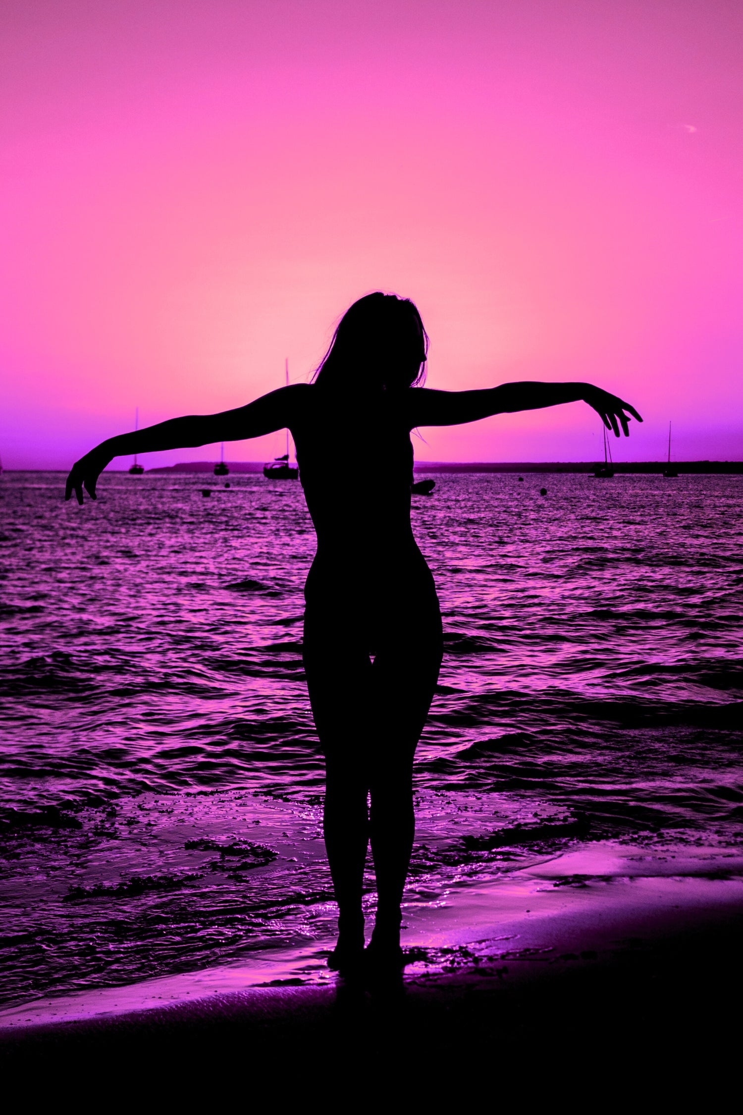 GIRL STANDING ON BEACH IN MALLORCA