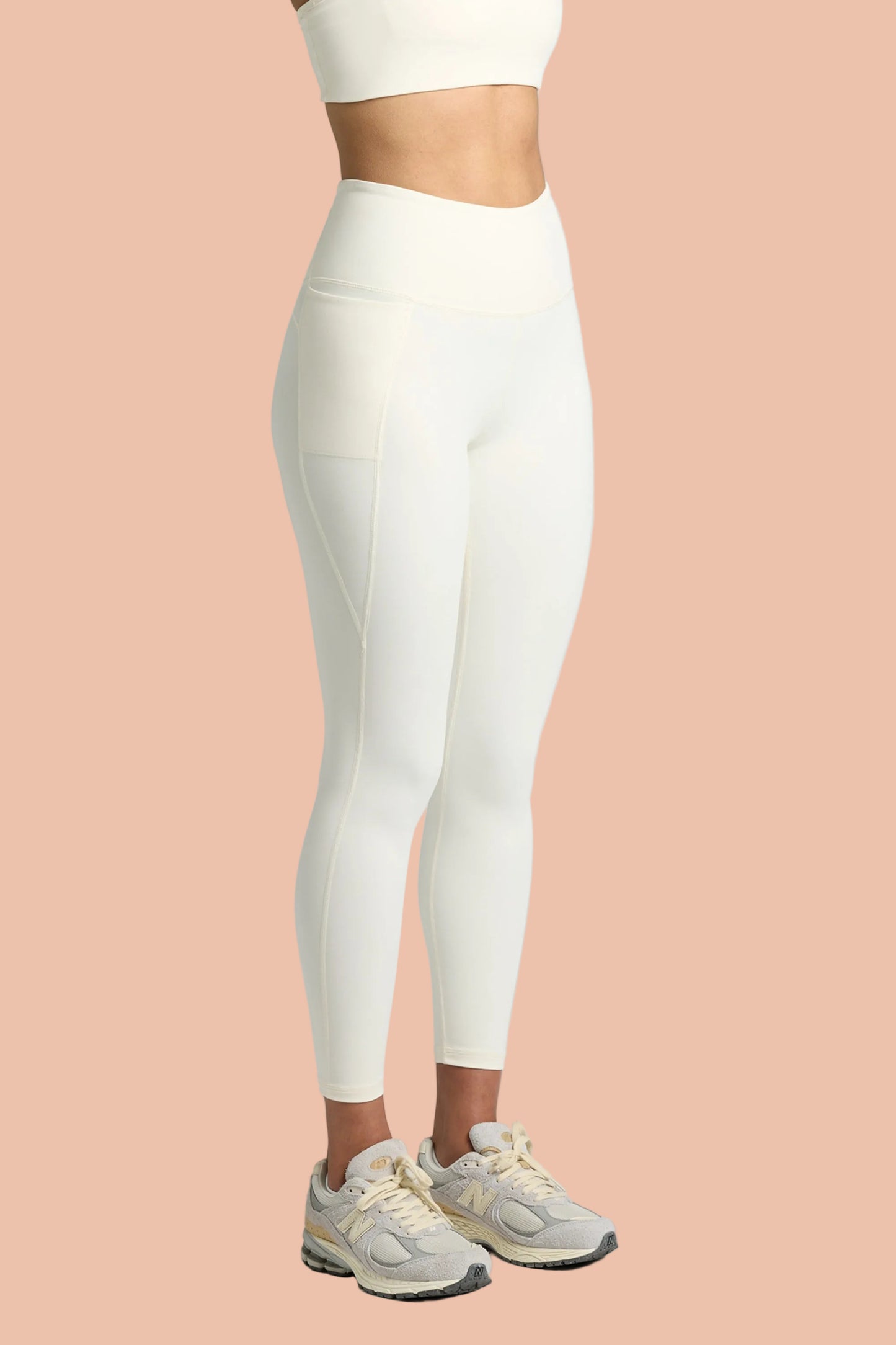 Model wearing MAREA Recycled Nylon Leggings in Ecru by Meraki Beach – sustainable high-waist activewear leggings made from ocean plastics