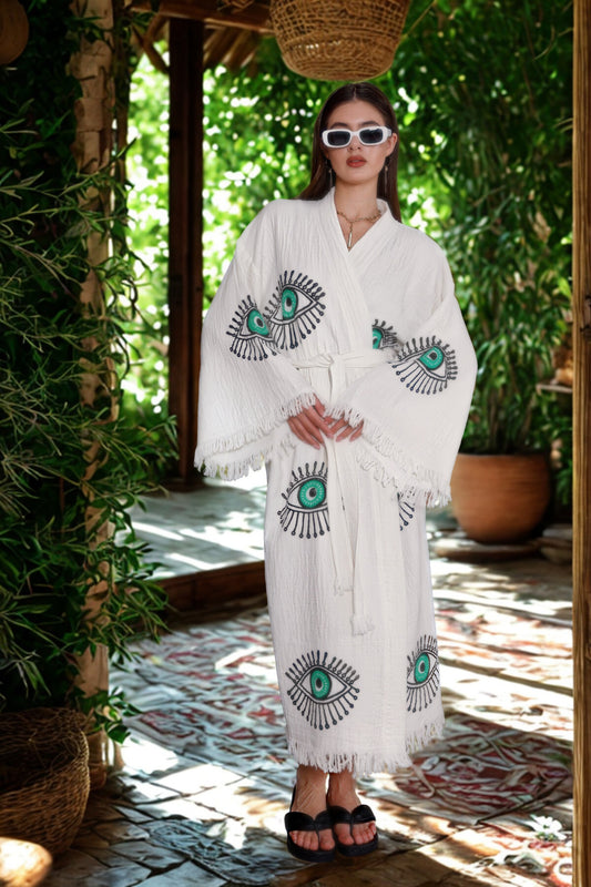 Model wearing the Amara Kimono – cream organic cotton kimono with jade green lucky eye motif, ethical resort wear by Meraki Beach