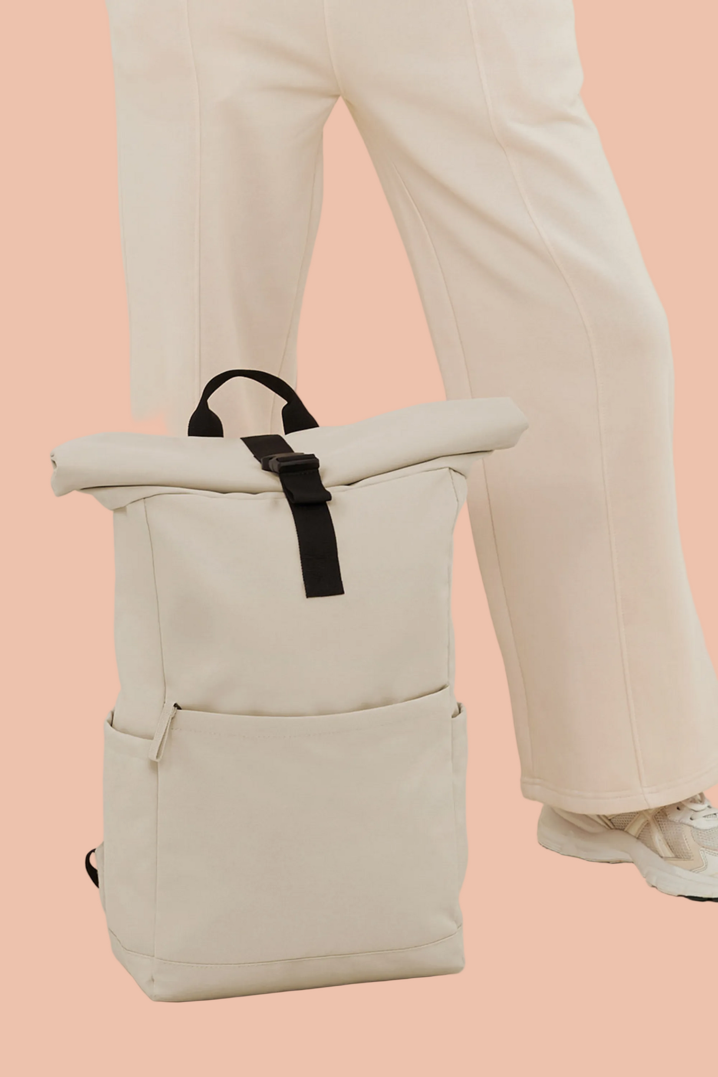 Woman with the Meraki Beach AVENTURA unisex roll-top backpack in Sandstone, minimalist sustainable bag designed for everyday adventure.