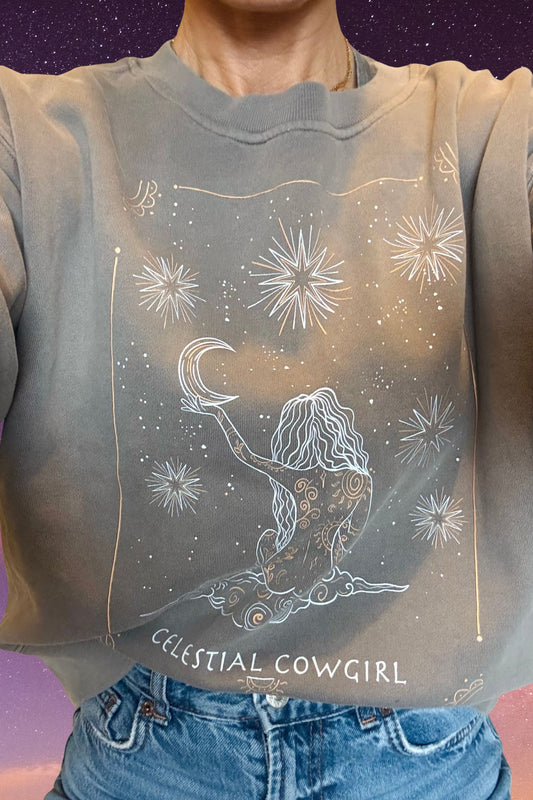 Model wearing Meraki Beach Celestial Cowgirl Sweatshirt in Grey, relaxed fit sustainable layer inspired by celestial and coastal adventures