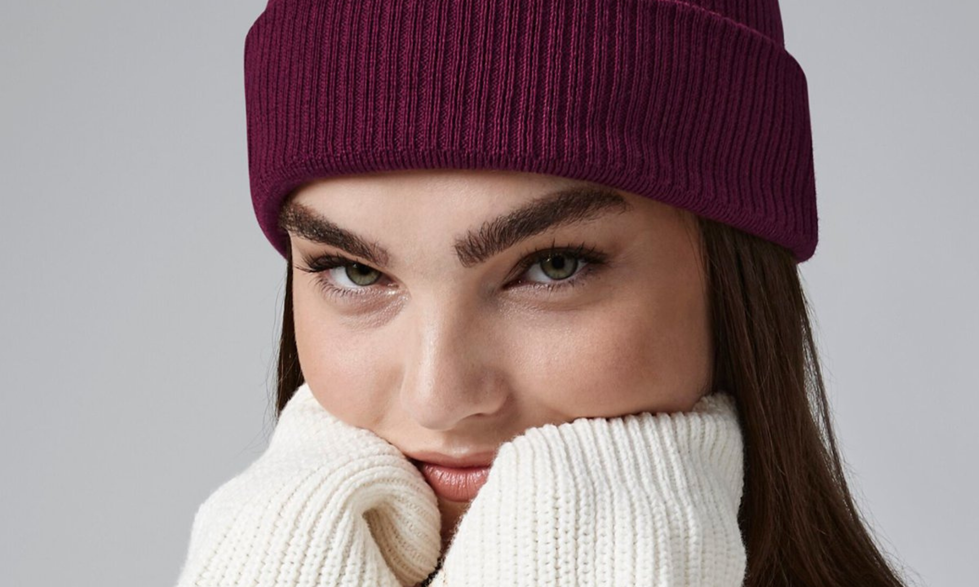 PRETTY GIRL WEARING OUR ORGANIC COTTON COVE BEANIE IN BERRY RED