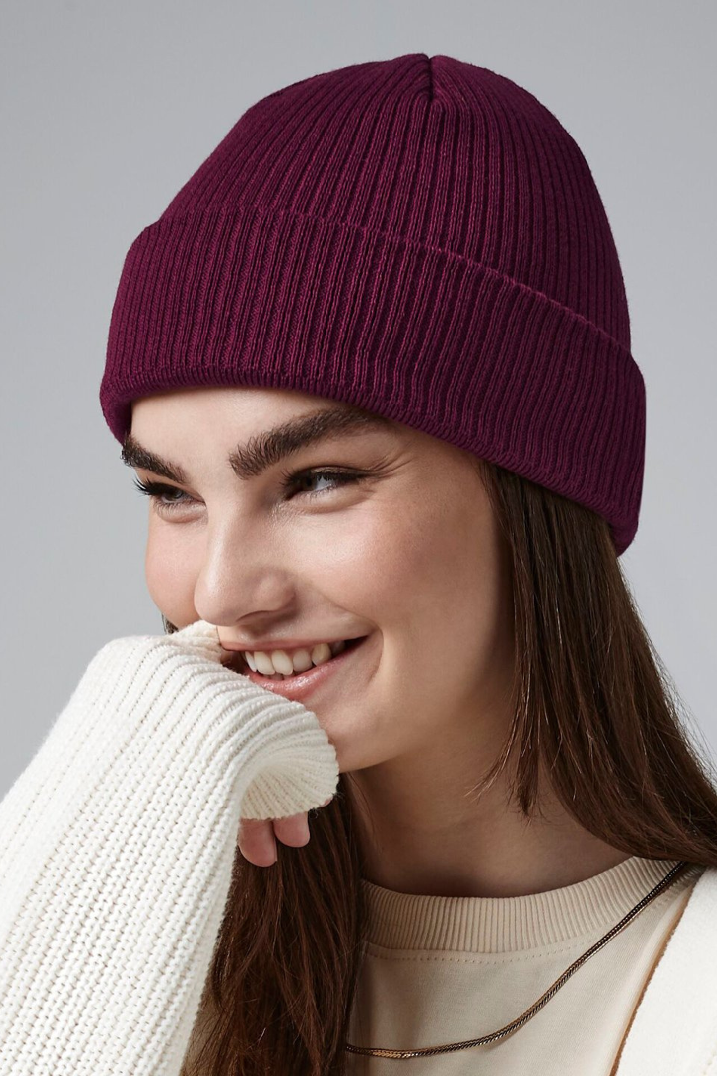 Model wearing The Cove Beanie in Berry by Meraki Beach – organic cotton rib knit hat in berry, sustainable unisex style