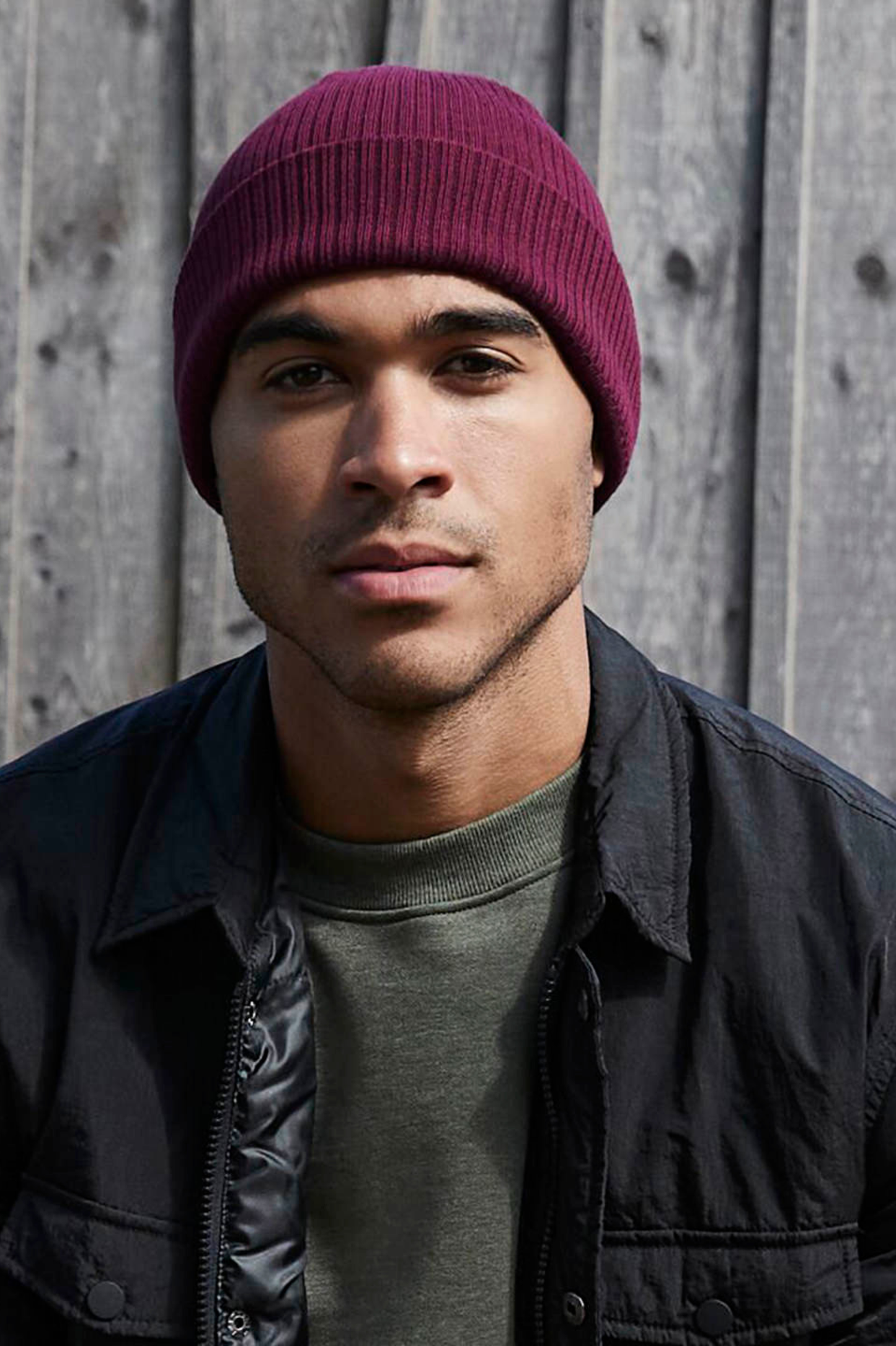 Model wearing The Cove Beanie in Berry by Meraki Beach – organic cotton rib knit hat in berry, sustainable unisex style