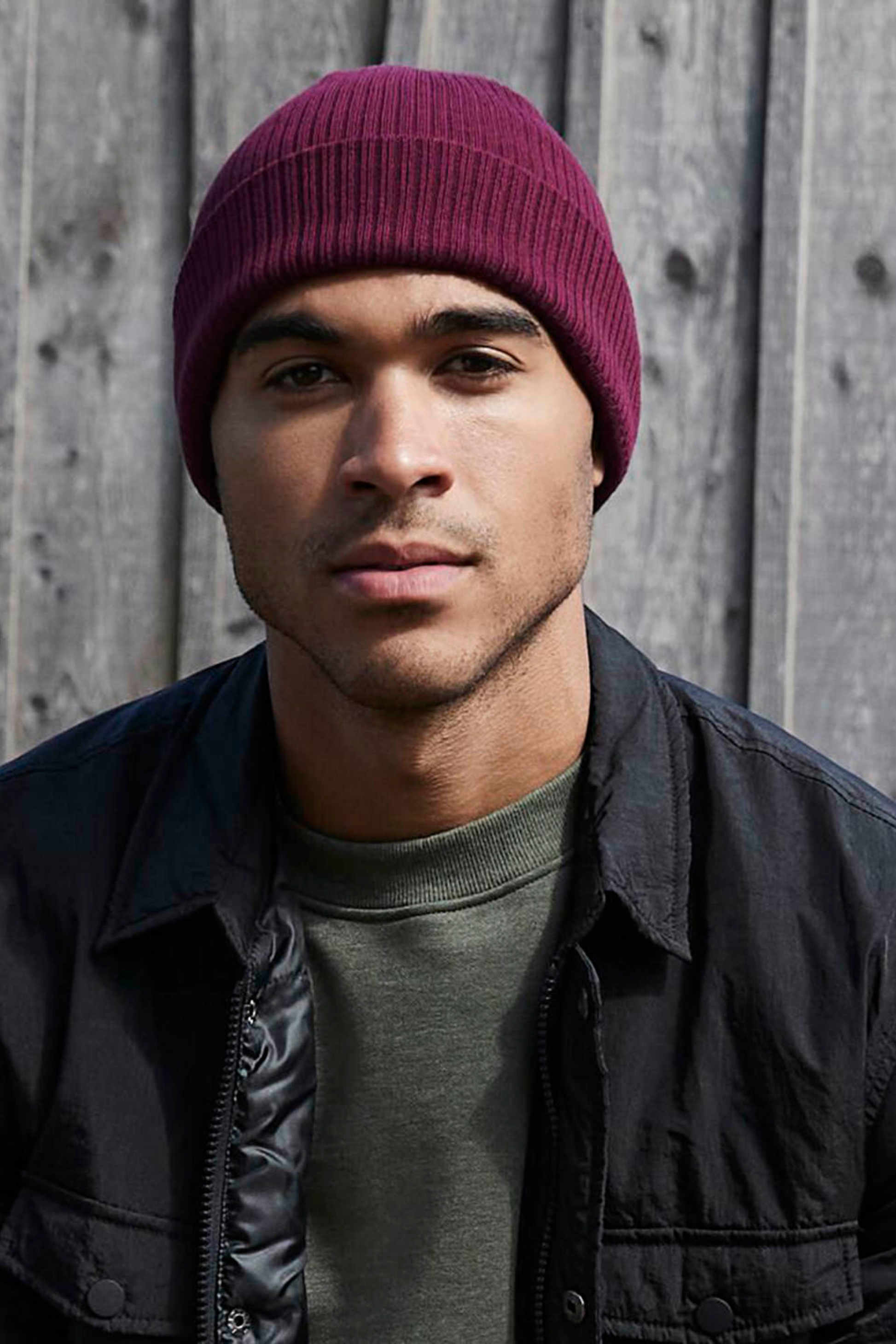 Model wearing The Cove Beanie in Berry by Meraki Beach – organic cotton rib knit hat in berry, sustainable unisex style