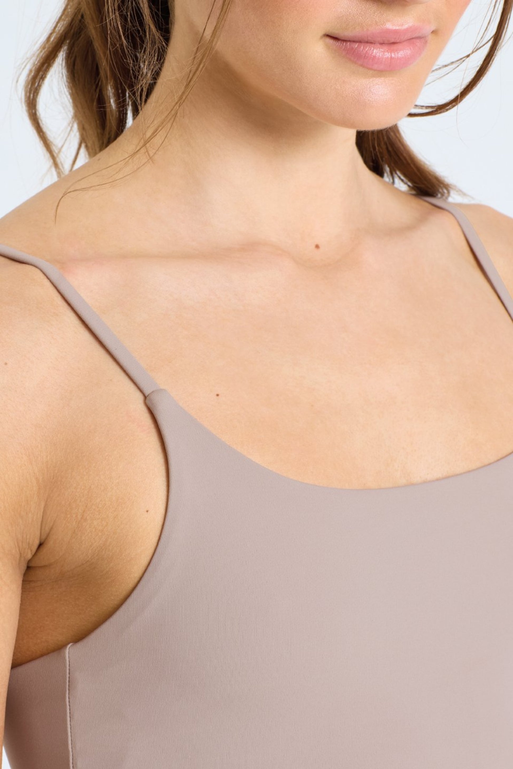 Woman wearing GAIA Recycled Luxe Gym Bra Top in Sandstone by Meraki Beach – sustainable activewear made from recycled nylon