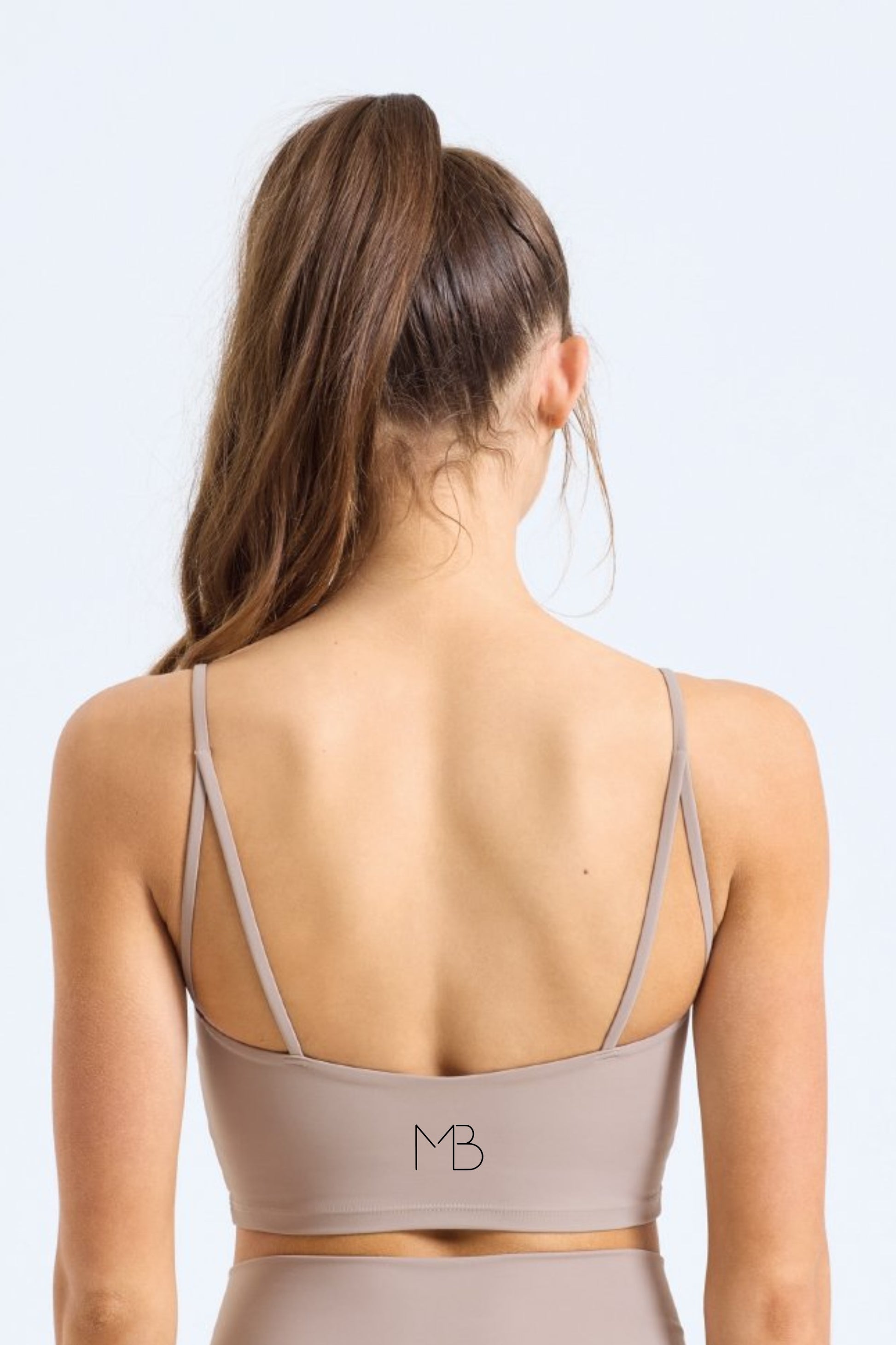 Woman wearing GAIA Recycled Luxe Gym Bra Top in Sandstone by Meraki Beach – sustainable activewear made from recycled nylon