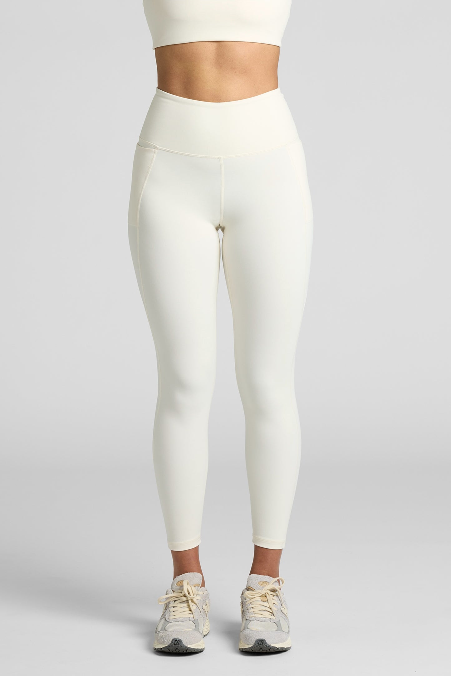 Model wearing MAREA Recycled Nylon Leggings in Ecru by Meraki Beach – sustainable high-waist activewear leggings made from ocean plastics