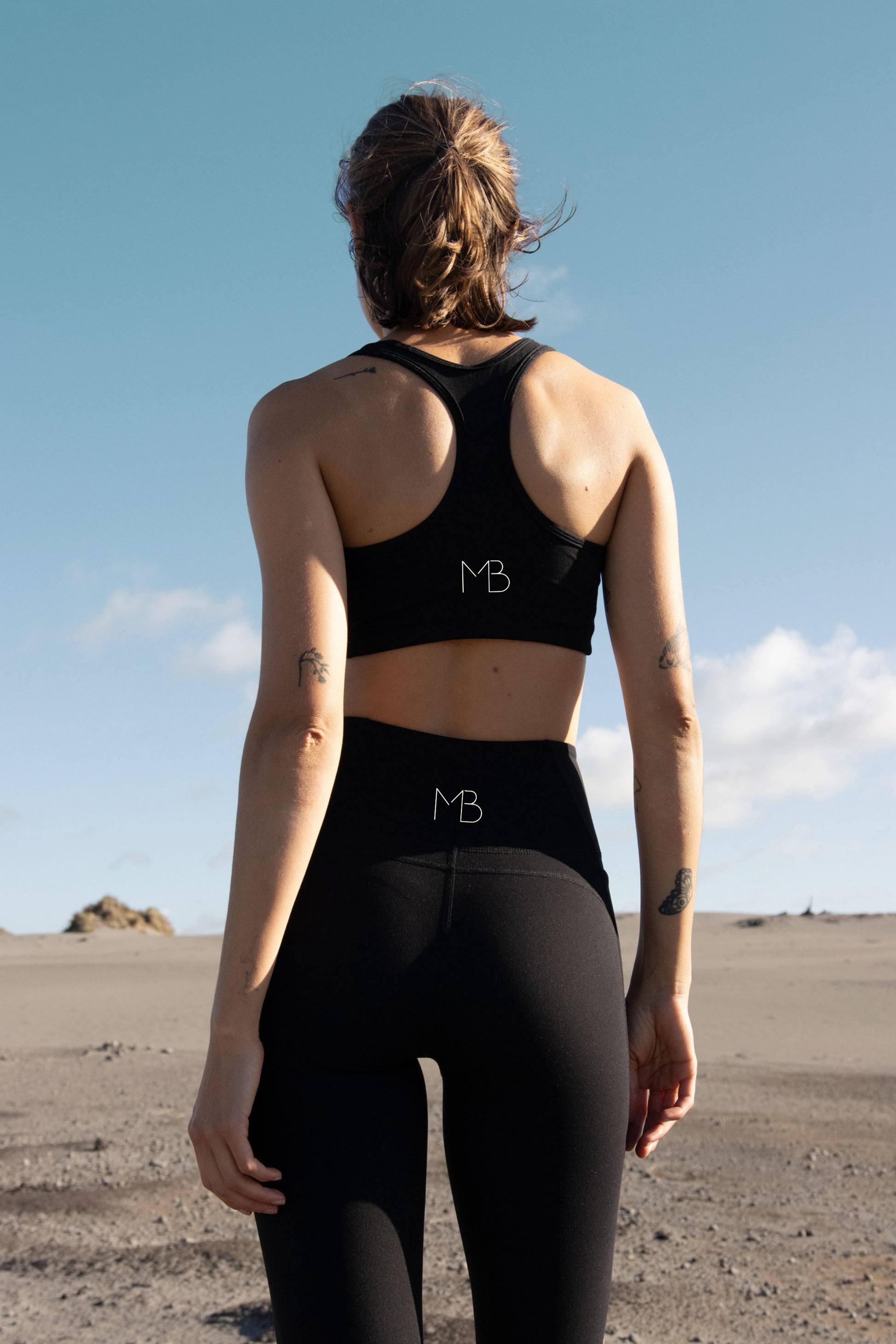 Model wearing MAREA Recycled Nylon Leggings in Black by Meraki Beach – sustainable high-waist activewear leggings made from ocean plastics