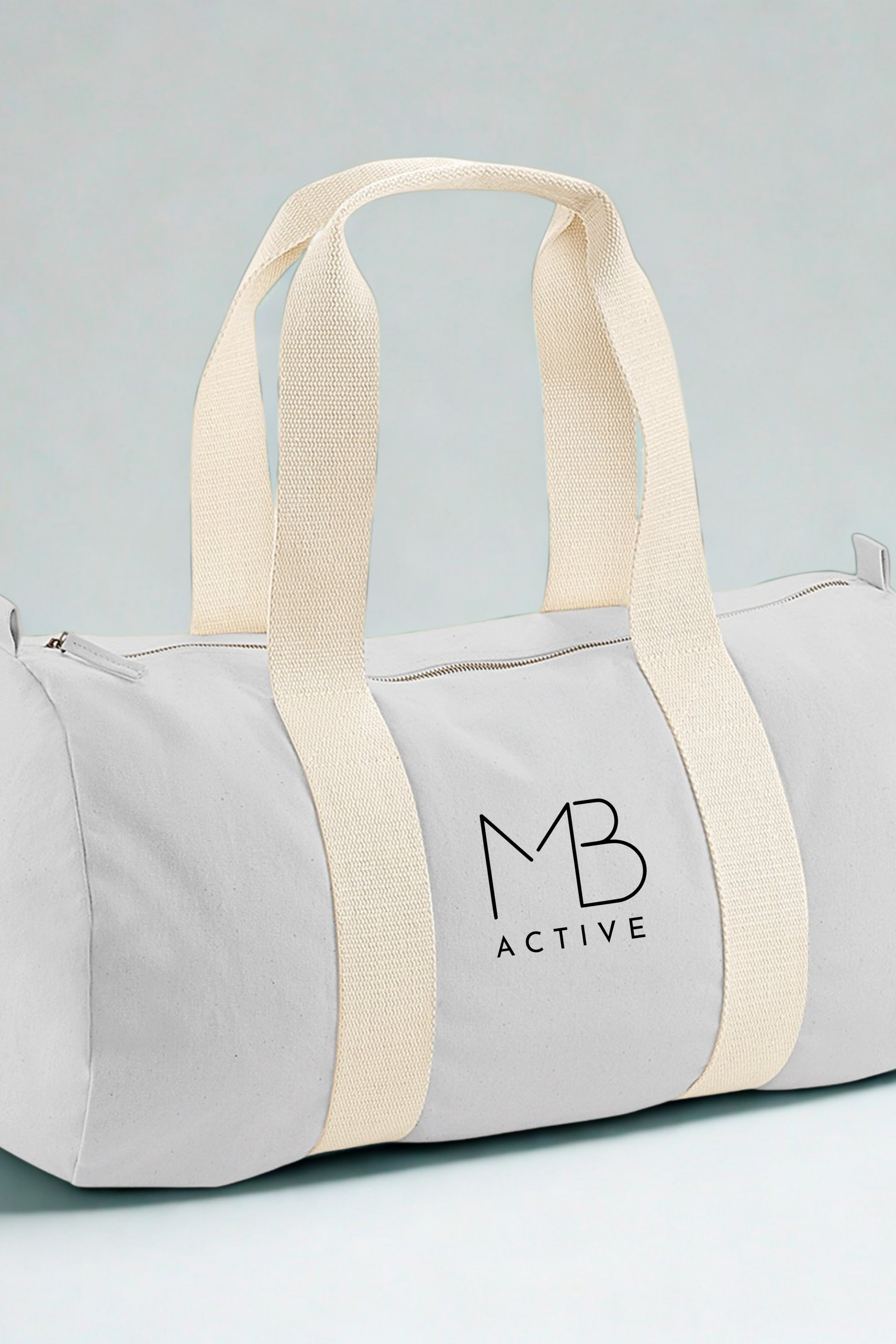 Light grey SOL organic cotton barrel bag with cream straps and 'MB Active' logo by Meraki Beach.