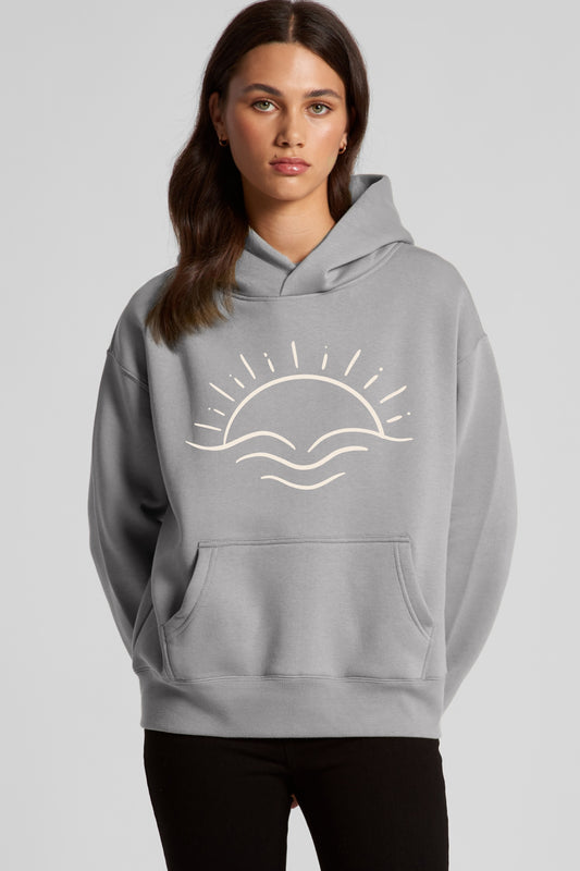 Model wearing LUMA Sustainable Relax Hoodie in Storm by Meraki Beach – recycled cotton fleece hoodie with sun design made from waste to wear materials