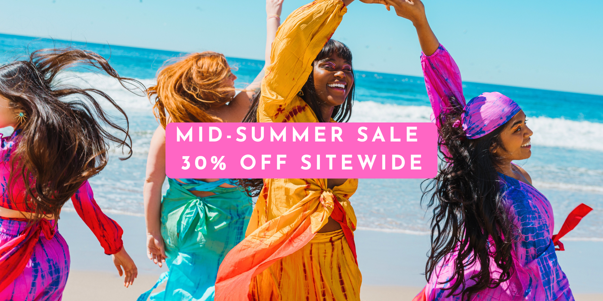 Four women in colorful silk outfits by Meraki Beach on a beach with a mid-summer sale banner overlay.