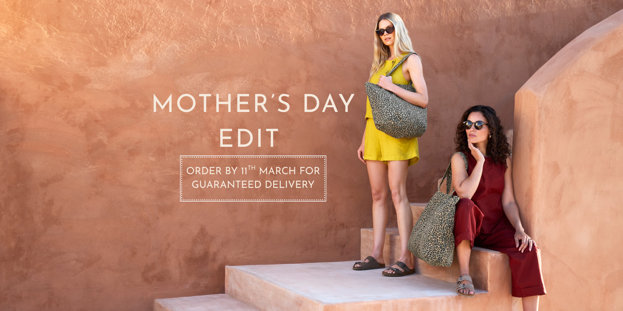 Two women with MERAKI BEACH sustainable handbags against a textured wall with 'Mother's Day Edit' text.
