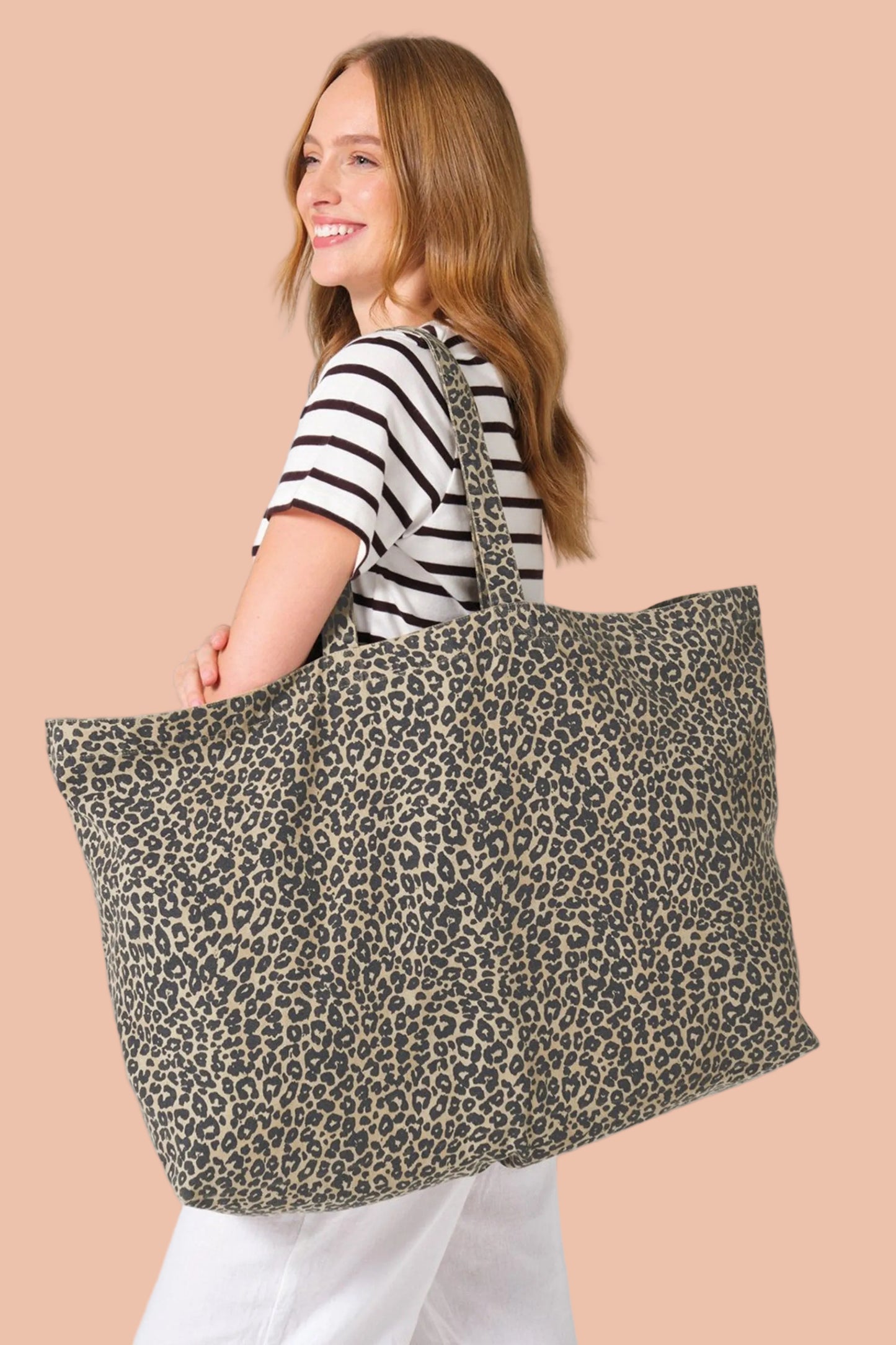 Woman carrying the NALA recycled cotton leopard print tote bag oversized canvas by Meraki Beach
