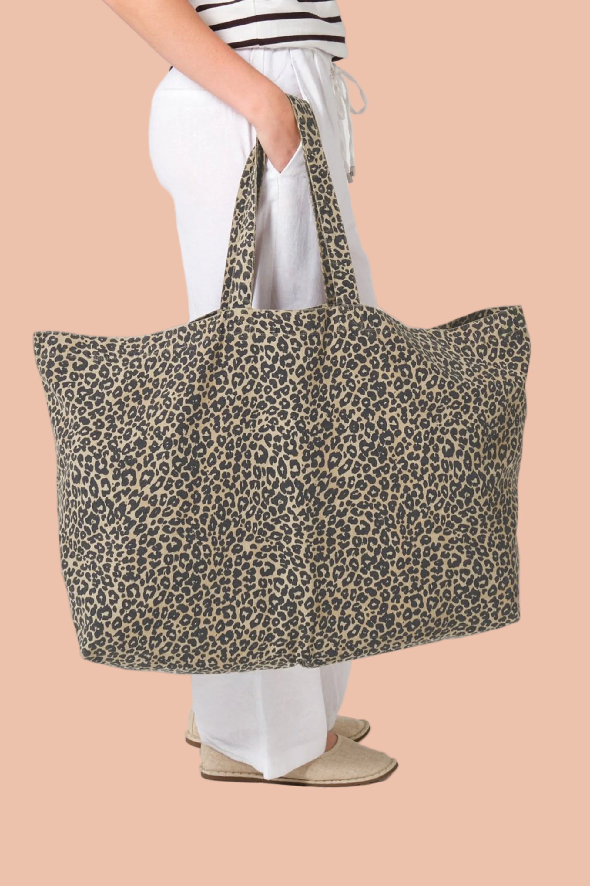 Woman carrying the NALA recycled cotton leopard print tote bag oversized canvas by Meraki Beach