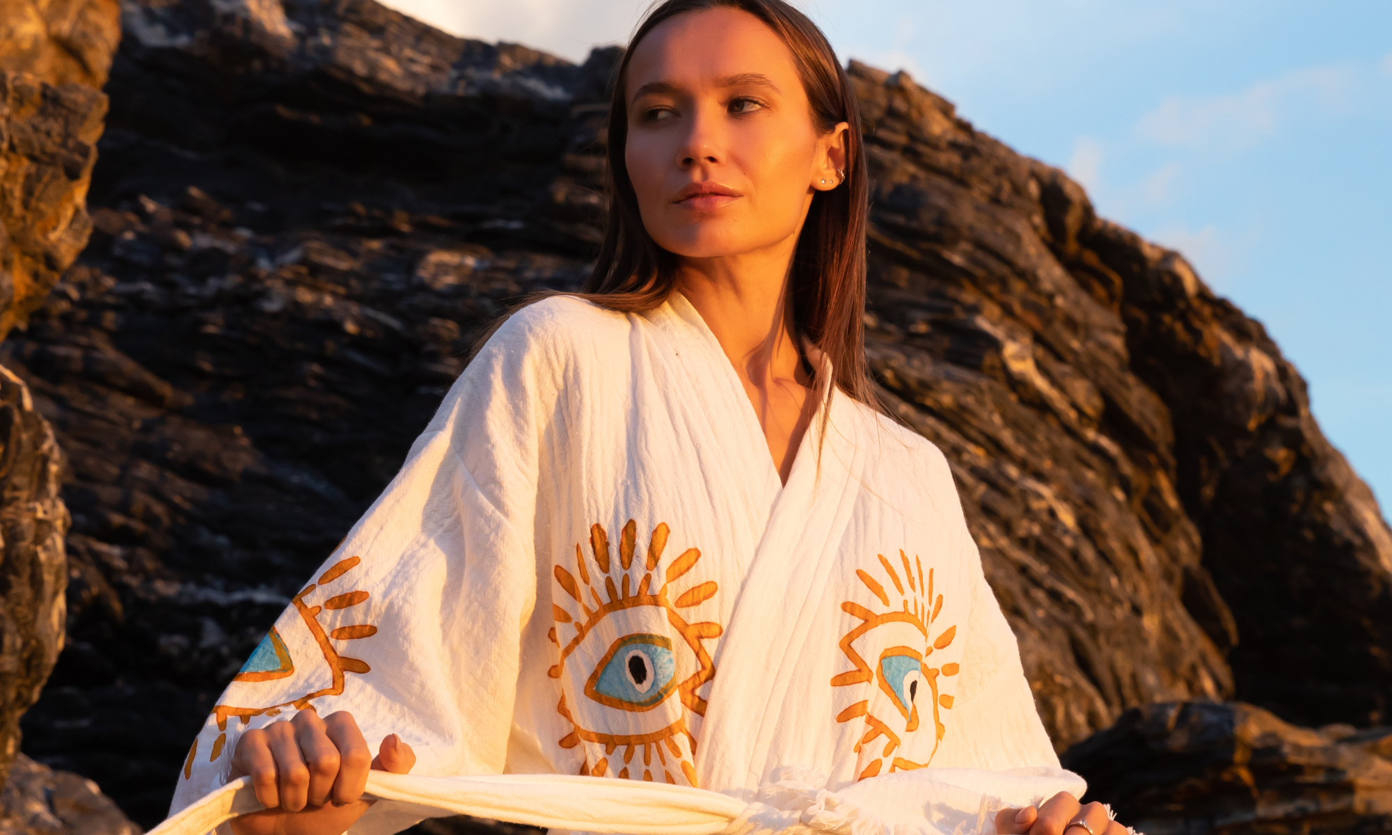 Woman wearing NAYA cream organic cotton kimono by Meraki Beach.