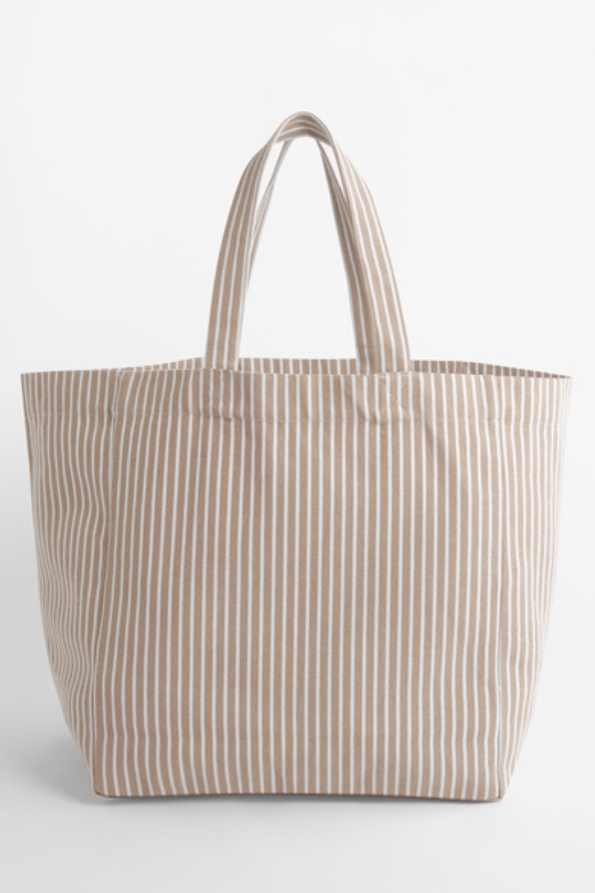 The NOLA sustainable Oversized Beach Bag in striped Biscuit by Meraki Beach