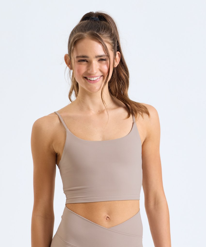 Woman wearing GAIA Recycled Luxe Gym Bra Top in Sandstone by Meraki Beach – sustainable activewear made from recycled nylon